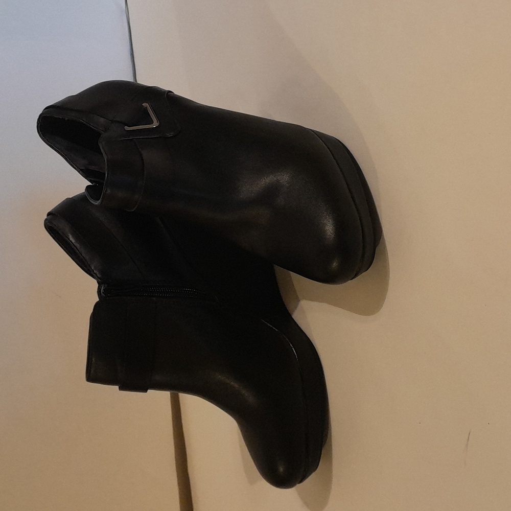 Here is a black high wedge shoe.